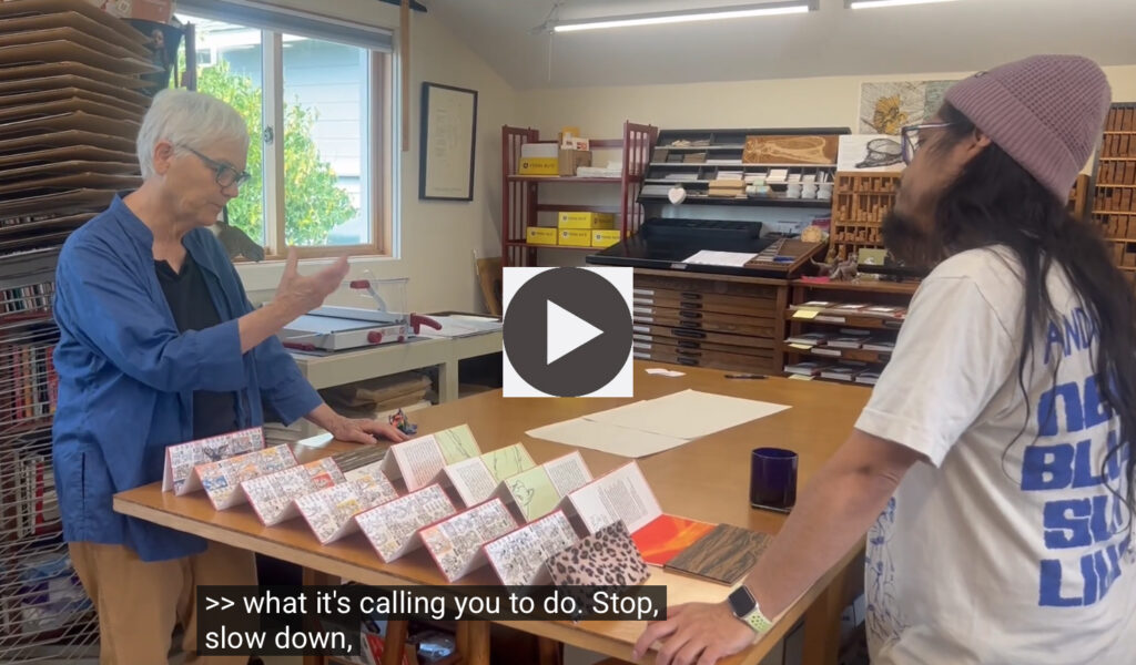 man and woman talk about book on table
