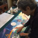 woman painting her artists' book spread