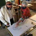 man and woman looking at artists' book