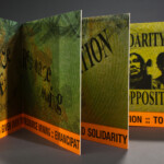 "The Necropolitics of Extraction" close-up colorful artists' book of prints and type