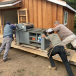 Men moving printing press