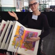 Woman with display of art books