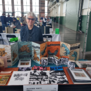 Woman with table of art books
