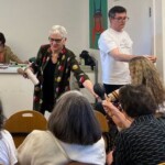 woman handing something out to audience members